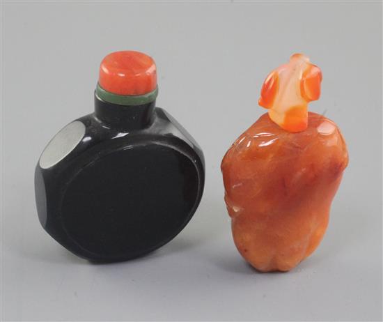 A Chinese chalcedony fruit form snuff bottle and a Chinese black glass watch-shaped snuff bottle